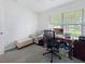 Bright home office with a large window, functional desk, comfortable chair, and ample workspace at 7292 Mikasa Dr, Punta Gorda, FL 33950