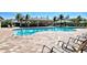 Community pool featuring lounge chairs, a covered seating area, and a refreshing swimming space at 7292 Mikasa Dr, Punta Gorda, FL 33950