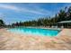 Inviting community pool is designed for relaxation and recreation with ample lounge chairs and shade for resident enjoyment at 7292 Mikasa Dr, Punta Gorda, FL 33950