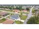 An aerial view showcases the neighborhood, nearby streets, landscaping, and architectural details of the house at 1007 Comstock St, Port Charlotte, FL 33952