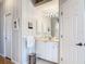 Bright bathroom with white vanity, striped wall paper and modern fixtures at 1007 Comstock St, Port Charlotte, FL 33952