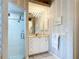 Bathroom features a glass-enclosed shower, vanity with storage, and modern fixtures at 1007 Comstock St, Port Charlotte, FL 33952
