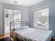 Bright bedroom with sliding glass doors, iron bed frame and a minimalist decor at 1007 Comstock St, Port Charlotte, FL 33952