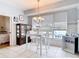 Dining area featuring a window with blinds, a white table, and a decorative chandelier at 1007 Comstock St, Port Charlotte, FL 33952