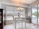 Dining area with tile floors, large window with blinds, and an adjacent sliding glass door to the pool at 1007 Comstock St, Port Charlotte, FL 33952