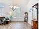 The dining room offers wood-look floors, large window, chandelier, and comfortable seating for a welcoming atmosphere at 1007 Comstock St, Port Charlotte, FL 33952