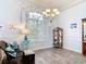 Dining room featuring light blue walls, wood-look floors, large window and chandelier for a cozy setting at 1007 Comstock St, Port Charlotte, FL 33952