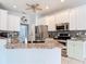 Kitchen featuring granite countertops, stainless steel appliances, light green cabinets and a kitchen island with sink at 1007 Comstock St, Port Charlotte, FL 33952