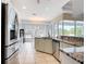 Well-lit kitchen with granite countertops, stainless steel appliances, and view of outdoor seating area at 1007 Comstock St, Port Charlotte, FL 33952