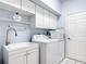 Laundry room features a sink, washer and dryer, and storage cabinets at 1007 Comstock St, Port Charlotte, FL 33952