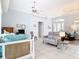 Spacious living room featuring tile floors, light blue walls, fan, and modern furniture at 1007 Comstock St, Port Charlotte, FL 33952