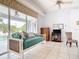 Comfortable living room showcases tile floors, light blue walls, fan, large window, and casual seating at 1007 Comstock St, Port Charlotte, FL 33952