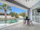 Beautiful outdoor patio featuring a swimming pool and table with chairs at 1007 Comstock St, Port Charlotte, FL 33952