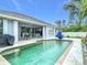 Backyard pool with spacious patio and a covered outdoor dining area at 1007 Comstock St, Port Charlotte, FL 33952