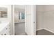 Bright bathroom featuring a walk-in closet, double vanity, and views into a bedroom at 10316 Hebblewhite, Englewood, FL 34223