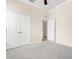Bedroom with plush carpeting, ample closet space, and doorway to additional room at 10316 Hebblewhite, Englewood, FL 34223