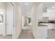 Open-concept interior featuring tile flooring, white cabinets, and an easy flow to the living area at 10316 Hebblewhite, Englewood, FL 34223