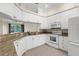 Modern kitchen featuring granite countertops, white cabinets, and appliances at 10316 Hebblewhite, Englewood, FL 34223