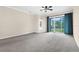 Open living room with neutral walls and sliding glass doors with access to outdoors at 10316 Hebblewhite, Englewood, FL 34223