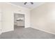 Open living room with neutral walls leading into the bright, white kitchen at 10316 Hebblewhite, Englewood, FL 34223