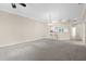 Open living room featuring neutral carpet, chandelier, and a convenient bar area at 10316 Hebblewhite, Englewood, FL 34223