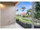 Screened-in patio overlooking manicured landscaping, and a tranquil waterway with swaying palms at 10316 Hebblewhite, Englewood, FL 34223