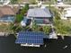 Aerial view of the property featuring a solar panel boat lift, private pool, and metal roof at 107 Sinclair Se St, Port Charlotte, FL 33952