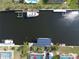 Scenic aerial view down the canal featuring multiple docks with solar panel boat lifts at 107 Sinclair Se St, Port Charlotte, FL 33952