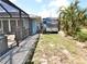 Home exterior featuring a paver walkway, RV, and a mix of plants and trees for private outdoor living at 107 Sinclair Se St, Port Charlotte, FL 33952