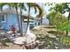 The backyard features lush tropical landscaping, a utility shed, and an AC unit at 107 Sinclair Se St, Port Charlotte, FL 33952