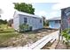 Spacious backyard featuring a shed with double doors and a paver path, perfect for outdoor activities at 107 Sinclair Se St, Port Charlotte, FL 33952