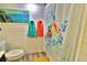 Bathroom with a turtle-themed shower curtain and colorful decor, offering a bright and cheerful atmosphere at 107 Sinclair Se St, Port Charlotte, FL 33952