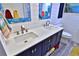 Bathroom featuring a double sink vanity with blue cabinets and brushed nickel fixtures at 107 Sinclair Se St, Port Charlotte, FL 33952