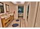 Bright bathroom with a double sink vanity, ample storage, and views to the bedroom at 107 Sinclair Se St, Port Charlotte, FL 33952