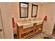 Bathroom features a double sink vanity with modern faucets and wooden cabinetry at 107 Sinclair Se St, Port Charlotte, FL 33952