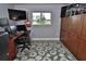 This bedroom features a built-in wooden closet, a mounted TV, and a window offering natural light at 107 Sinclair Se St, Port Charlotte, FL 33952