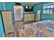 Well-lit bedroom showcasing a TV and dresser, with attractive wood-look floors and coastal accents at 107 Sinclair Se St, Port Charlotte, FL 33952