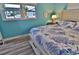 Cozy bedroom with a coastal theme, featuring a comfortable bed and pleasant natural light at 107 Sinclair Se St, Port Charlotte, FL 33952