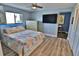 Comfortable bedroom featuring a TV, chest of drawers, and ample natural light at 107 Sinclair Se St, Port Charlotte, FL 33952