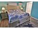 Inviting bedroom with coastal-themed decor, featuring a comfortable bed and warm, ambient lighting at 107 Sinclair Se St, Port Charlotte, FL 33952