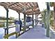 Covered boat lift with solar panels on the roof. A sign reminds users of the safety guidelines at 107 Sinclair Se St, Port Charlotte, FL 33952
