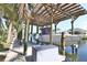 Covered boat dock featuring a boat lift and space for multiple vessels to make the most of waterfront living at 107 Sinclair Se St, Port Charlotte, FL 33952