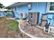 Home exterior featuring a pool heater, A/C unit, and kayaks for outdoor fun, showcasing backyard amenities at 107 Sinclair Se St, Port Charlotte, FL 33952