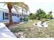 A beautifully landscaped front yard with tropical plants, palm trees, and decorative white rock features, adding to the curb appeal at 107 Sinclair Se St, Port Charlotte, FL 33952