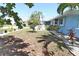 A well-maintained front yard featuring tropical plants and decorative white rock accents, enhancing the property's curb appeal at 107 Sinclair Se St, Port Charlotte, FL 33952