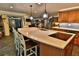 Spacious kitchen showcasing a large island with sink and seating, open to the dining and living areas at 107 Sinclair Se St, Port Charlotte, FL 33952