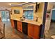 Kitchen featuring bar seating and views of the pool, ideal for indoor-outdoor living and entertaining at 107 Sinclair Se St, Port Charlotte, FL 33952