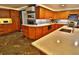 Open-concept kitchen featuring ample cabinetry, stone countertops, a large island, and unique tile flooring at 107 Sinclair Se St, Port Charlotte, FL 33952