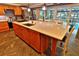 Bright kitchen with an expansive island, stainless steel appliances, and an adjacent view of the pool area at 107 Sinclair Se St, Port Charlotte, FL 33952