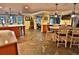 Open kitchen with large island, dining area, tile flooring, and views to the outdoor living space at 107 Sinclair Se St, Port Charlotte, FL 33952